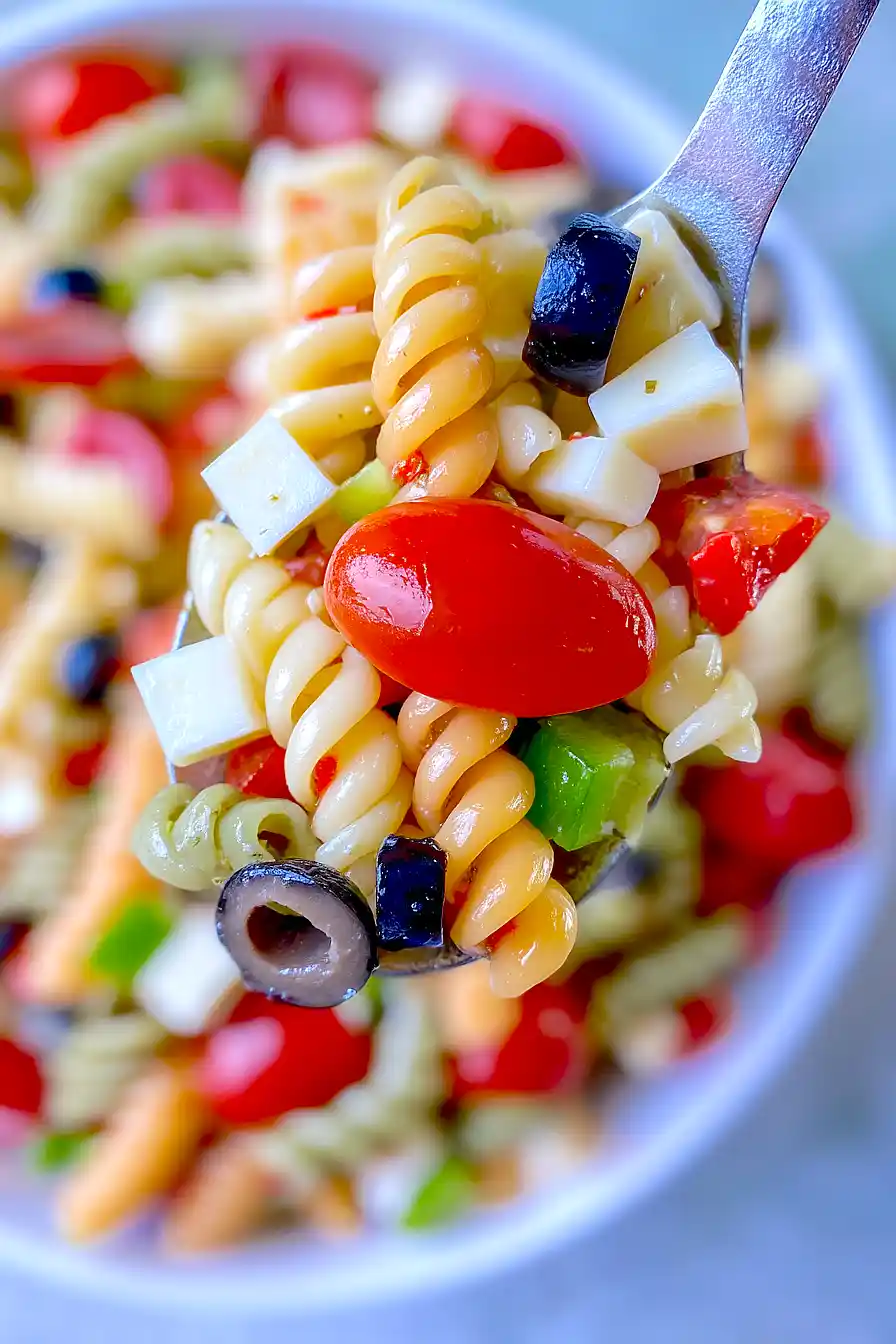 Tri colored rotini pasta salad with cherry tomatoes